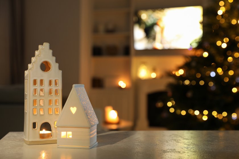 Beautiful house shaped candle holders on table indoors, space for text. Bokeh effect Beautiful house shaped candle holders on table indoors, space for text. Bokeh effect