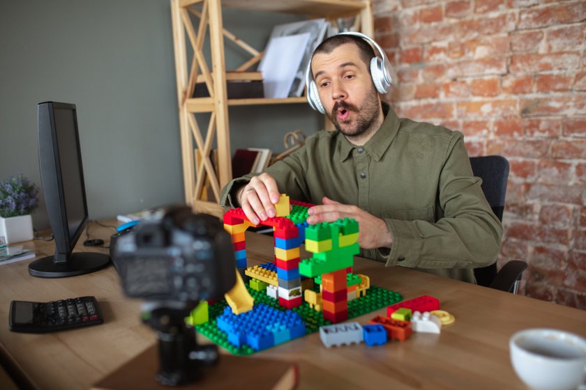 Mann spielt mit Lego