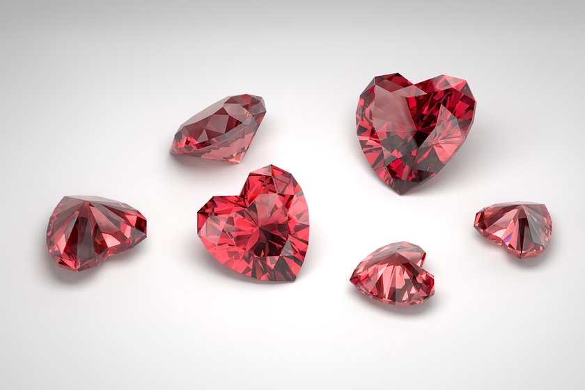 Scattering of rubies of different sizes on the white background. Exhibition of precious stones. Cut in heart style. 3d rendering. Scattering of rubies of different sizes on the white background. Exhibition of precious stones. Cut in heart style. 3d rendering.