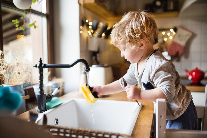 Montessori Gadgets: Kind benutzt Küchenspüle mit Lernturm
