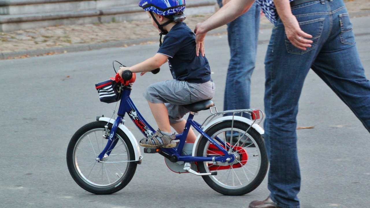 Der Fahrradhelm schützt den Kopf des Kindes beim Radfahren.