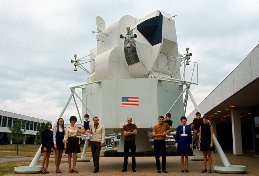 Portrait of the original, prime Apollo 13 (Apollo XIII) crew, Jim Lovell (center left), Ken Mattingly (center), and Fred Haise (center right) as they pose with their families in front of a space module, February 1970. From left, the Lovells (daughters Susan and Barbara, wife Marilyn, son Jeff, and Jim), Mattingly, and the Haise family (Fred, son Stephen, wife Mary, son Fred, and daughter Mary). Mattingly was replaced by John Swigert shortly before the mission launch.