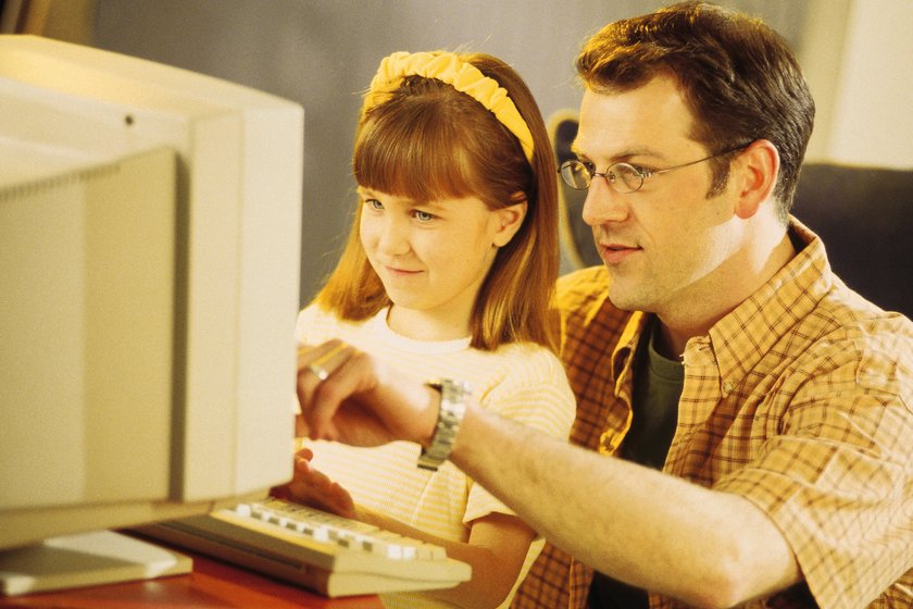 Mädchen und Vater vorm Computer