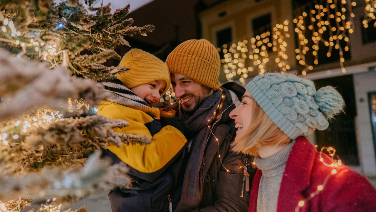 Photo of a young family celebrating Christmas outdoors