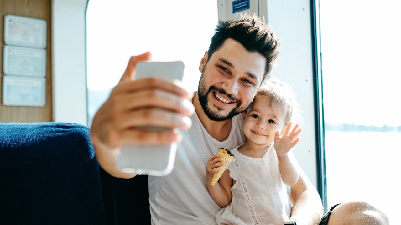 Father with daughter taking selfie