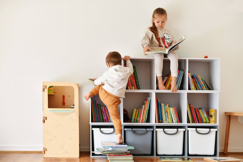 Brother and sister reading books in the children s room Brother and sister reading books in the white children s room Copyright: xKUCHUGURINAxIRINA RECORD DATE NOT STATED