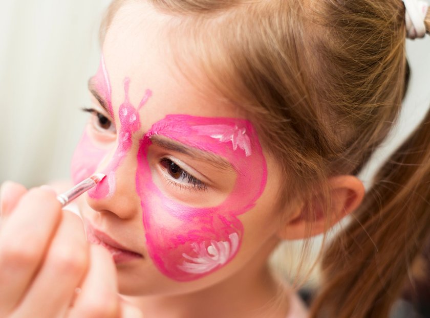 Cute little girl having her face painted. AdobeRGB photo.