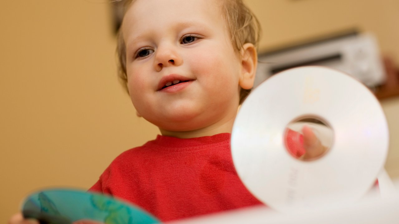 child with CD  (compact disc) listening to music, canon 5D, ISO100