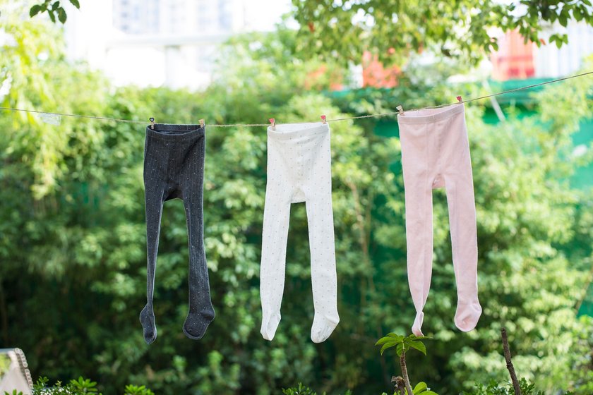 Kids wearing colorful rainbow socks. Children footwear collection. Variety of knitted knee high socks and tights. Child clothing and apparel. Kid fashion. Legs and feet of little boy and girl group.