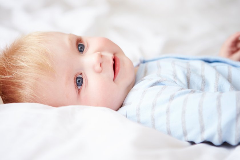 Young Baby Boy Lying In Bed