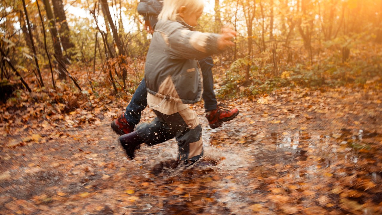 Mother and child in the park in autumn day